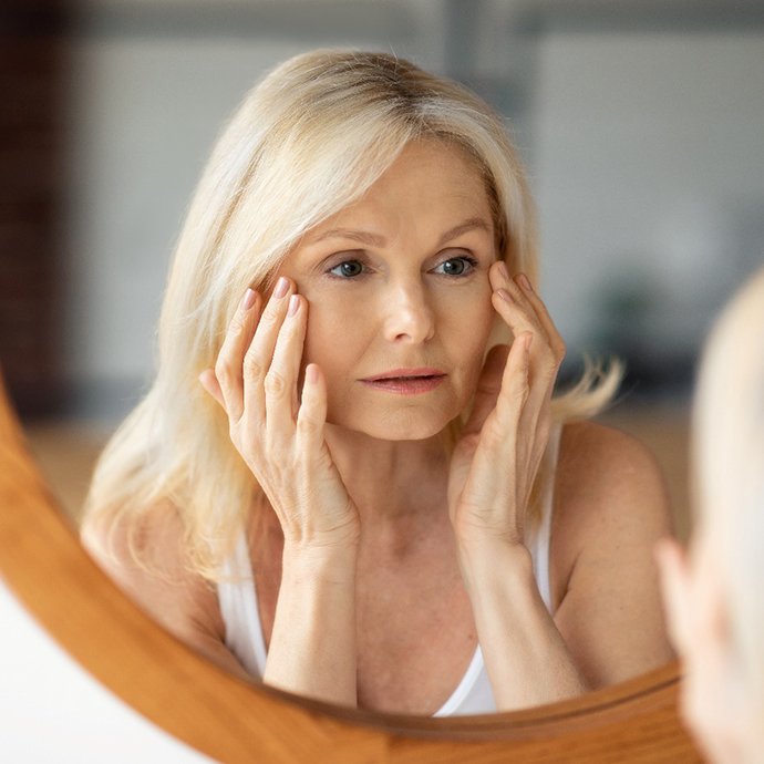 a woman looking in a mirror