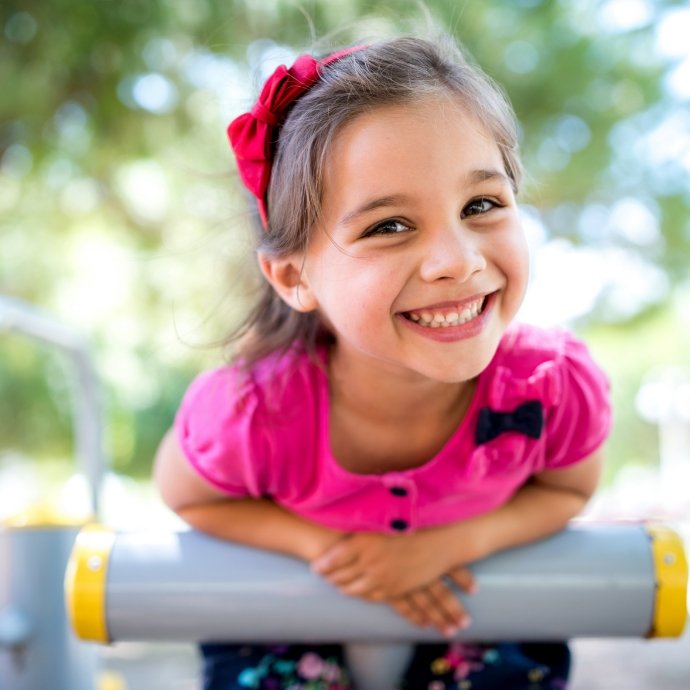 Young girl smiling after children's dentistry checkup and teeth cleaning