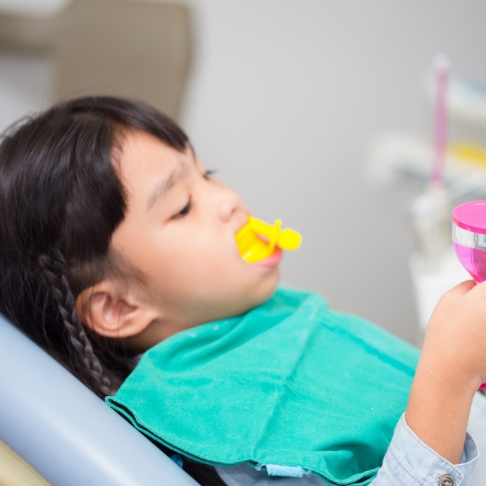 Child receiving fluoride treatment