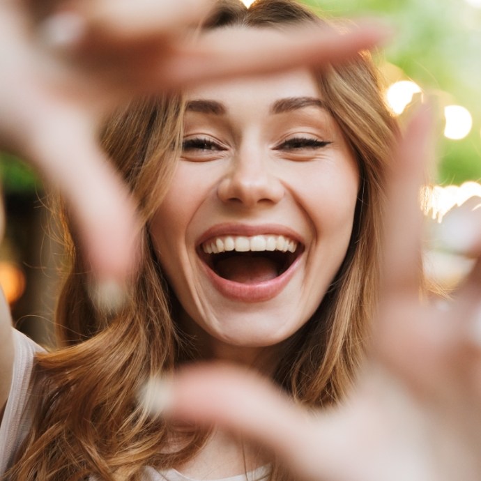 Woman showing off smile after makeovers