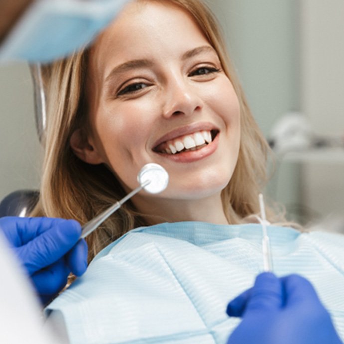 Woman smiling while visiting cosmetic dentist in Longmont