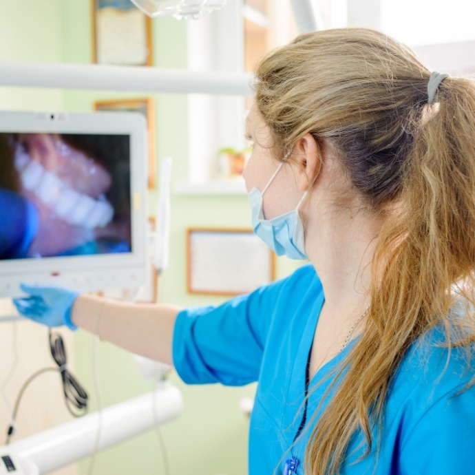 Dentist looking at images capture with intraoral camera