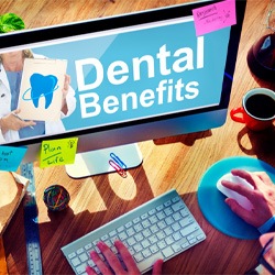 a computer with the words “dental benefits” on the screen