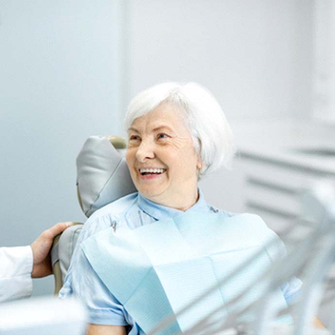 Dentist in Longmont speaking with an older patient