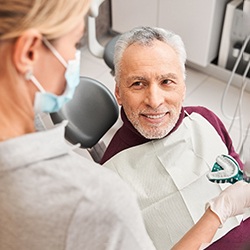 A dentist presenting dental impressions for dentures to her patient