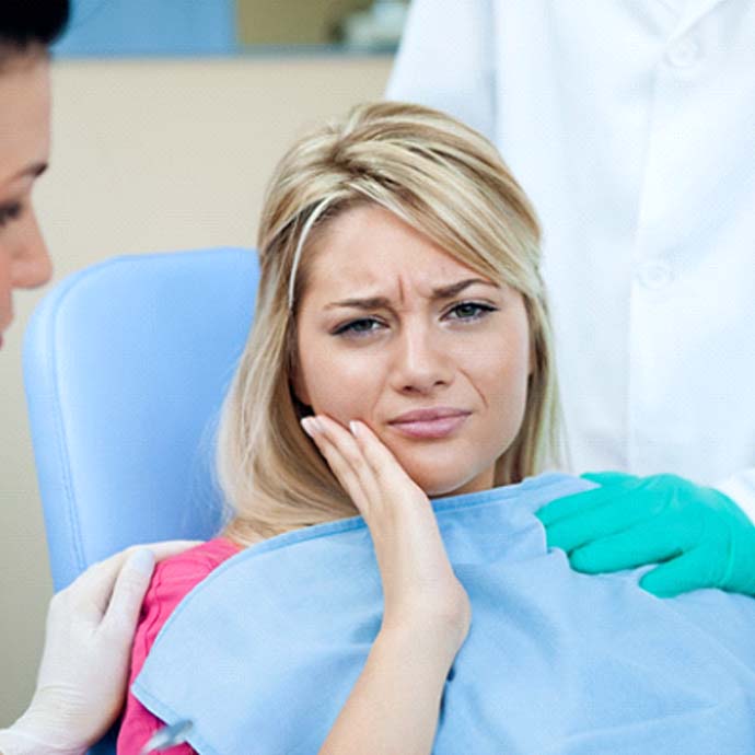 Woman thinking about cost of dental emergencies in Longmont
