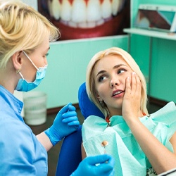 woman visiting dentist for dental emergency in Longmont