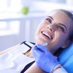 woman smiling during dental checkup in Longmont