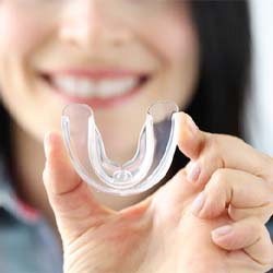 woman holding up mouthguard