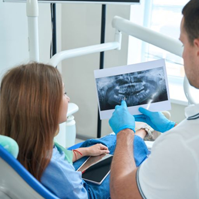 Dentist and patient reviewing X-ray together