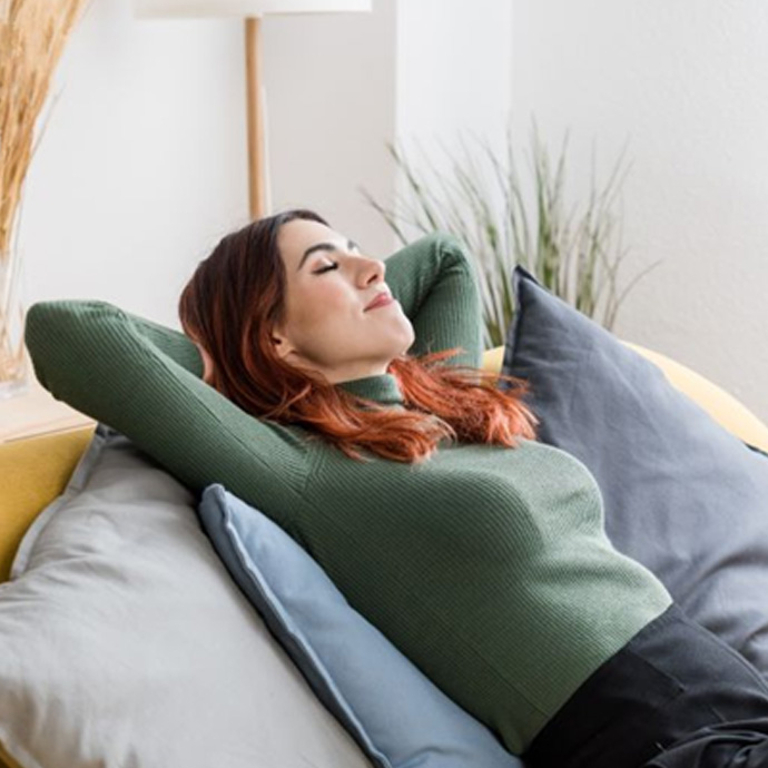 Woman relaxing on her sofa at home