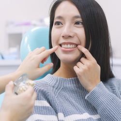 a woman receiving her dental implant restorations