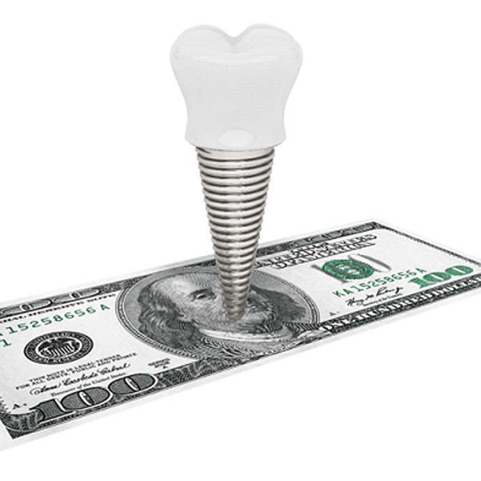 model of dental implant standing on top of a 100 dollar bill