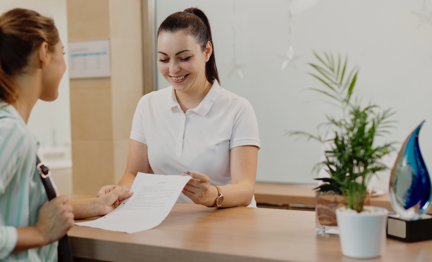 Dental team member discussing financing options with patient