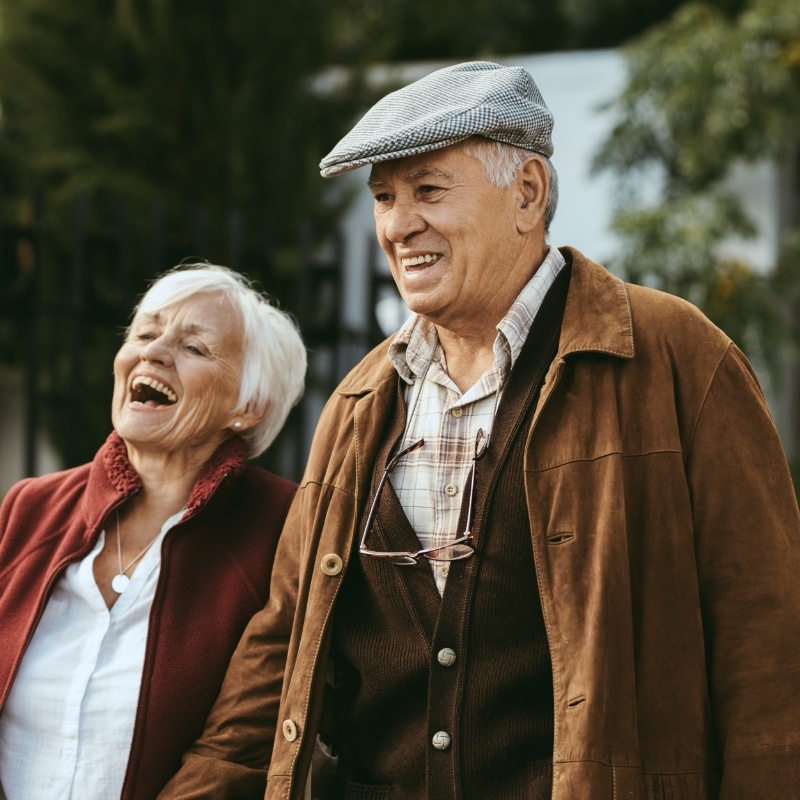 Man and woman smiling outside