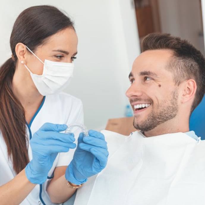 Patient and dentist discussing the cost of Invisalign in Longmont