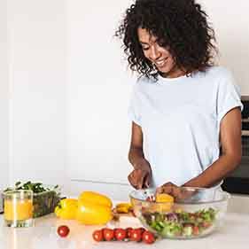 Woman preparing healthy meal in white kitchen