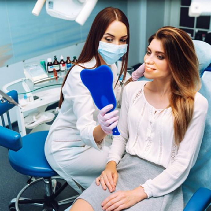 a patient checking her smile after LANAP surgery