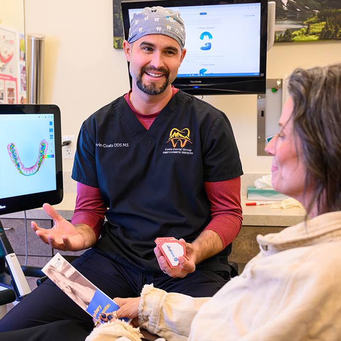 Dentist and team member treating dental patient