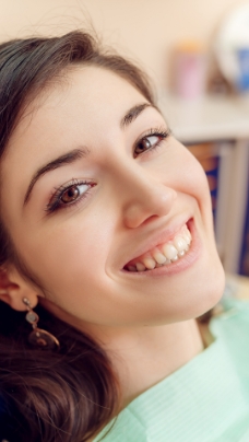 Woman smiling during preventive dentistry visit