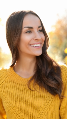 Woman with healthy smile after receiving dental services