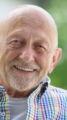 Man with healthy smile after replacing missing teeth