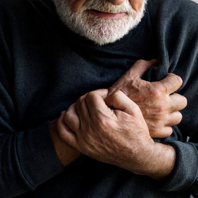 man holding chest in distress