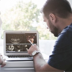 dental professionals looking at digital scans