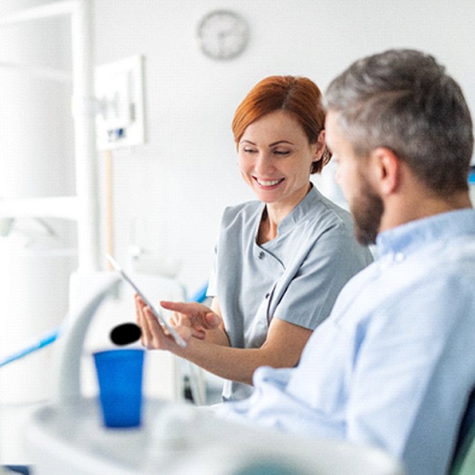 dentist talking with a patient about veneers in Longmont