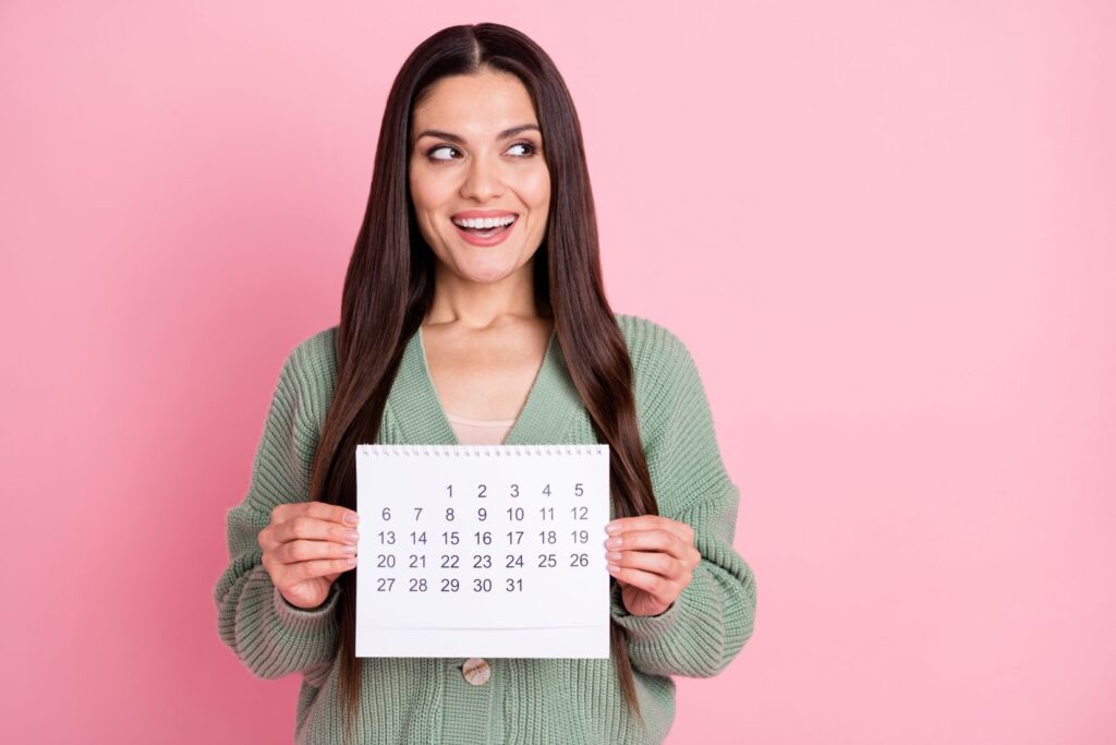 A woman holding a calendar