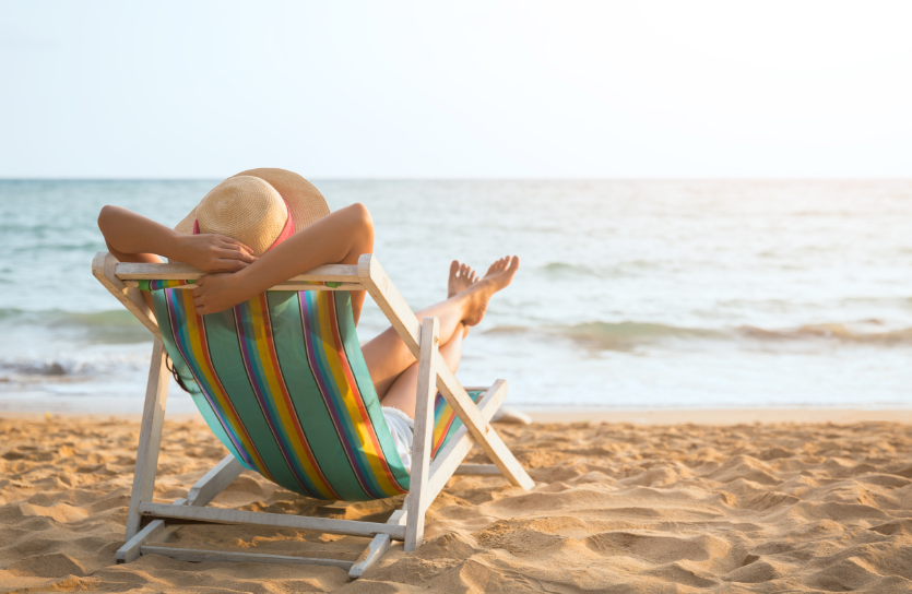 Woman relaxing in chair on beach